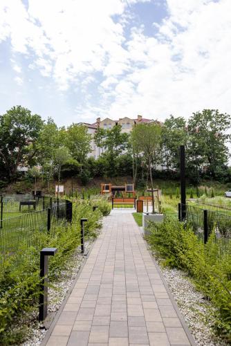 a walkway in a park with a playground at Apartament LUNA z jacuzzi Premium na Mazurach in Ełk