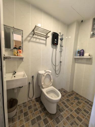 a bathroom with a toilet and a sink at Langkawi Simfoni Platinum Suite in Kuah