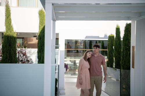 a couple standing in front of a house at Lagon Life Spirit Boutique Hotel - Adults Only in Chania Town