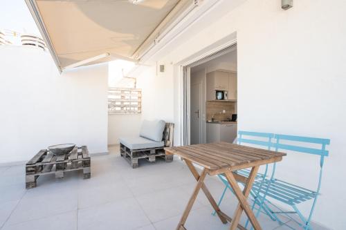 a room with a wooden table and a chair at RoofTop Sea View Cabin in Vari