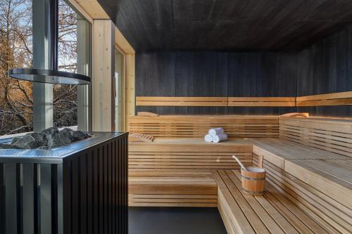 a sauna with a hot tub in a house at Romantik Hotel Schweizerhof & Spa Flims in Flims