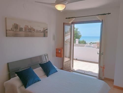 a bedroom with a bed with a view of the ocean at AT Chalet Stella con Piscina Privada in Peniscola