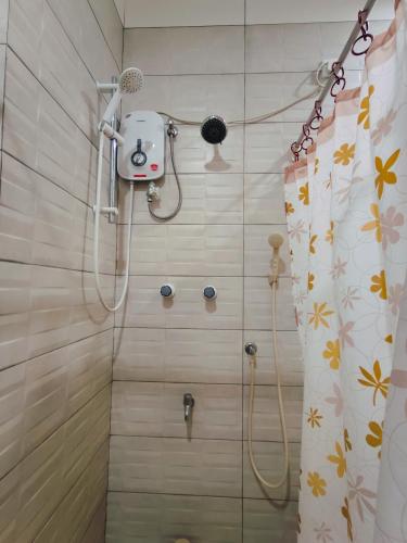 a shower in a bathroom with a shower curtain at Royal Point Arugambay in Arugam Bay