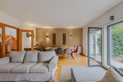 a living room with a couch and a table at Casa das Fontes - House of Wells in Parede