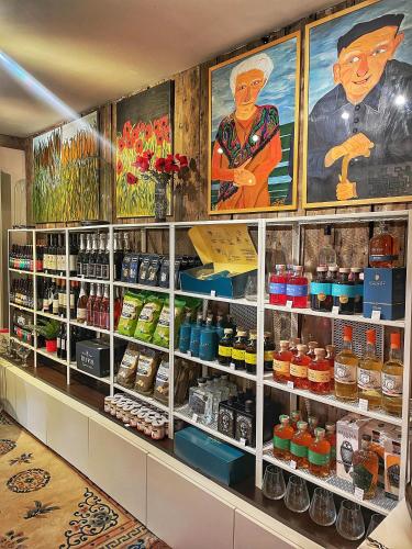 a store shelf filled with lots of drinks and posters at L'Art de la fugue in Daverdisse