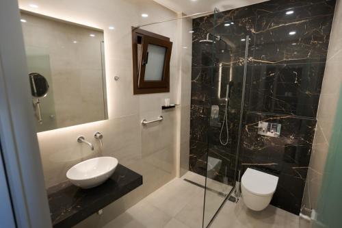a bathroom with a sink and a shower at The Mark Hotel in Gliki