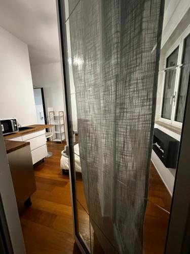 a glass door in a room with a kitchen at Suite Fiore in Bari