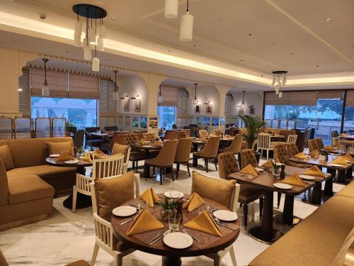 a dining room with tables and chairs and tablesktop at Tajview, Agra-IHCL SeleQtions in Agra
