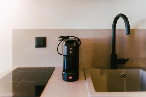 a blender sitting on a counter next to a sink at LAN-GO SIVOTA Luxury Living in Sivota