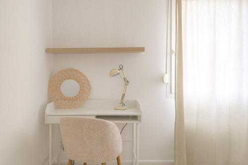 a white desk with a chair and a mirror at Cosy au centre d’Oullins avec garage in Oullins