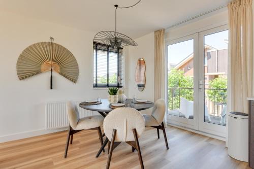 a dining room with a table and chairs at Meerzicht 61 - Luxury 4 person apartment in Uitgeest