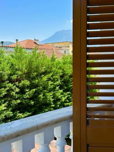 a balcony with a view of trees and mountains at Guest House Pulake in Berat
