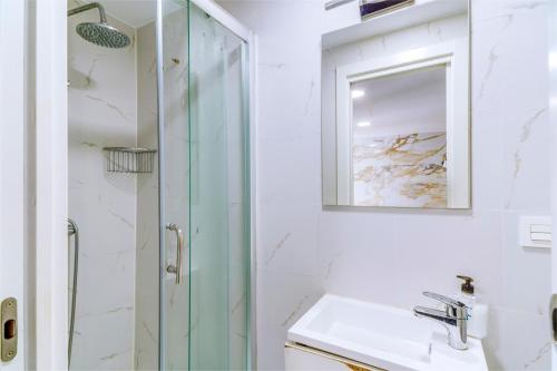 a bathroom with a shower and a sink and a mirror at SL Marbella in Marbella