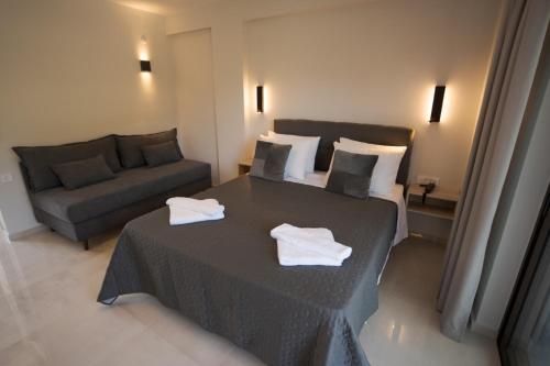 a hotel room with a bed and a couch at The Mark Hotel in Gliki