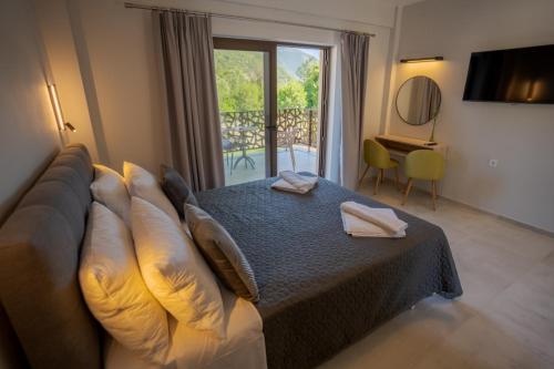 a hotel room with a bed and a balcony at The Mark Hotel in Gliki