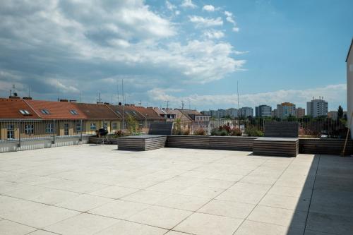 a large patio with buildings and a city in the background at Apartmány Gočárova třída in Hradec Králové