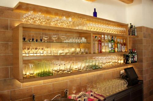 a bar with many wine glasses on a wall at Bílý Beránek in Hladov