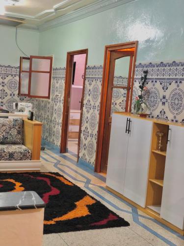a room with a living room with a rug at Peaceful and cozy appartement, very good location in Sidi Slimane