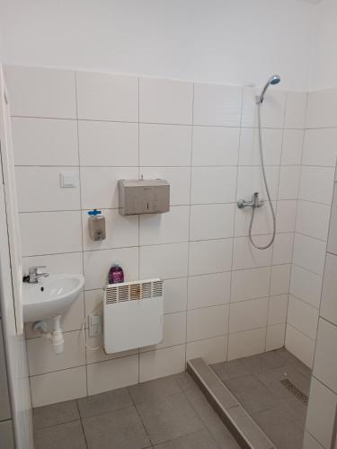 a bathroom with a shower and a sink at Czyli Chill in Nisko