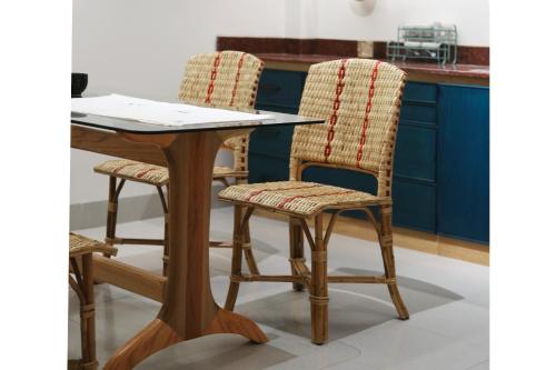 a wooden table and two chairs at a kitchen counter at Lela Stay in Tuy Hoa