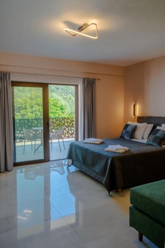a hotel room with a bed and a balcony at The Mark Hotel in Gliki