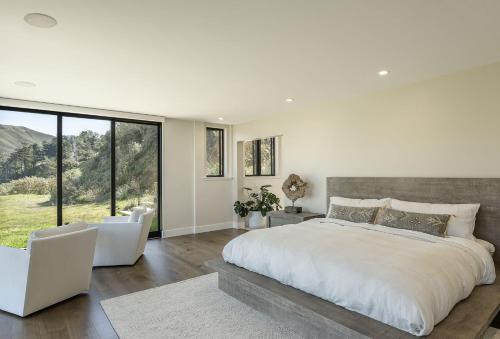 a bedroom with a large bed and a large window at 3920 Red Tail Hawk home in Carmel