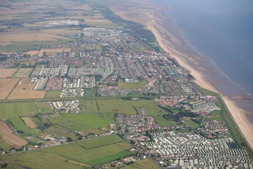 an aerial view of a city next to the beach at Wonderful 6 Berth Caravan With Decking & River Views At Heacham Beach Ref 21003A in Heacham