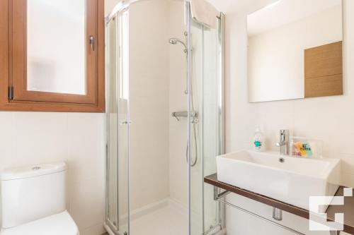 a bathroom with a shower and a toilet and a sink at Villa Mirador de Bassetes 14 - Grupo Turis in Calpe