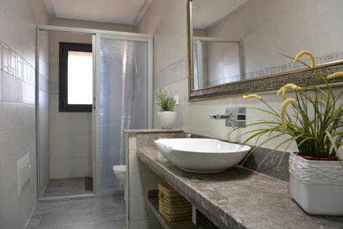 a bathroom with a white sink and a shower at Atlas Royale Marrakech in Marrakesh