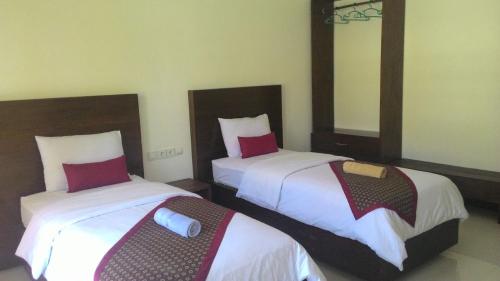 Кровать или кровати в номере Alam Mimpi Hotel
