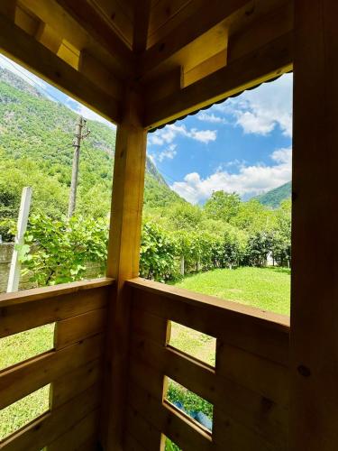 a window in a room with a view of a mountain at Mountain Oasis in Valbonë