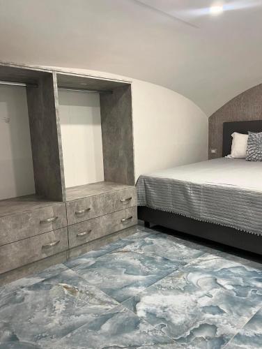 a bedroom with two beds and a marble floor at Aurora House 2 in Naples
