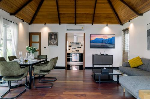 a living room with a table and a couch at Luxurious Residence Rawai in Phuket Town