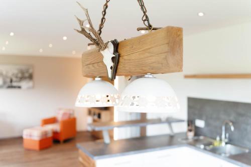 a kitchen with two lights hanging from the ceiling at SCHMID Ferienwohnungen in Ofterschwang