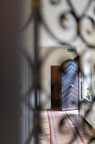 a blue door in a room with a rug at Suite Stays by Hotel La Perla in Ascona
