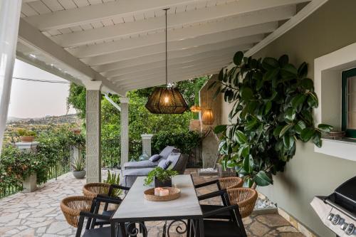 a patio with a table and chairs and a couch at Ermioni Countryside Residence by Konnect, Agios Markos in Ágios Márkos