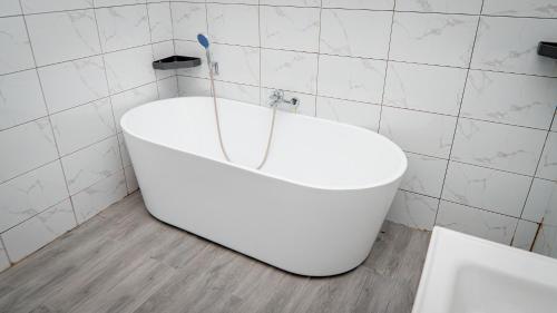 a white bath tub in a bathroom with a toothbrush at Mboka Village in Kahama
