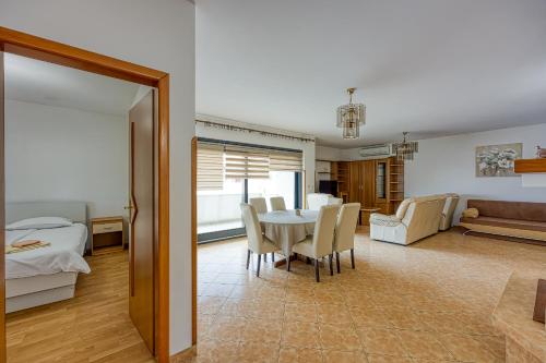 a dining room and living room with a table and chairs at Apartments Punta in Poreč
