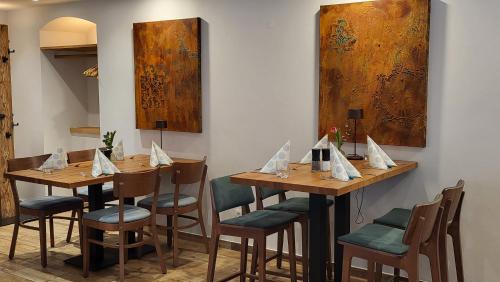 a dining room with wooden tables and chairs at Die Alte Schmelz in Bad Dürkheim