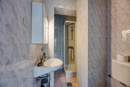 a bathroom with a sink and a shower at Apartments Punta in Poreč