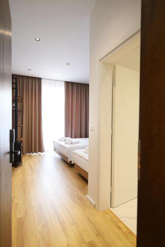 a bedroom with two beds and a large mirror at Mezzanine Bay in Himare