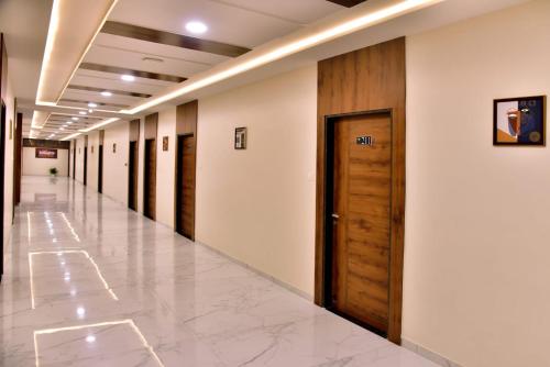 an empty hallway of a hospital with wooden doors at Hotel Wing Orbit in Bāli