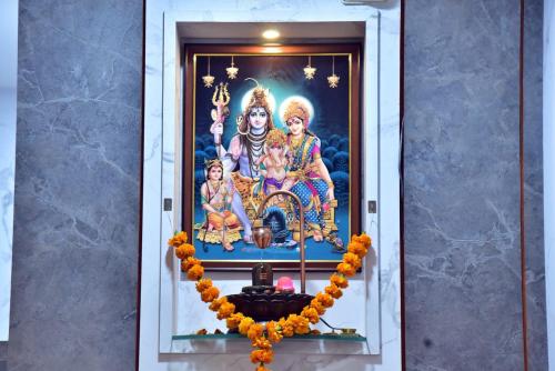 a temple with a picture of deities on the wall at Hotel Wing Orbit in Bāli
