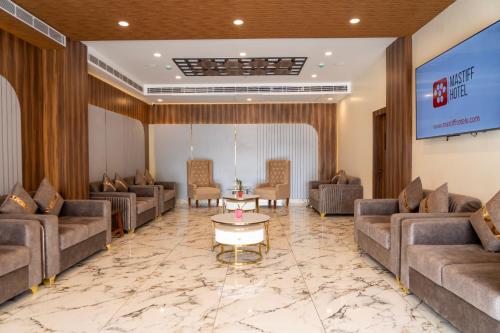 a lobby of a hotel with couches and a table at Mastiff Select Medha Plaza Deoghar in Deoghar