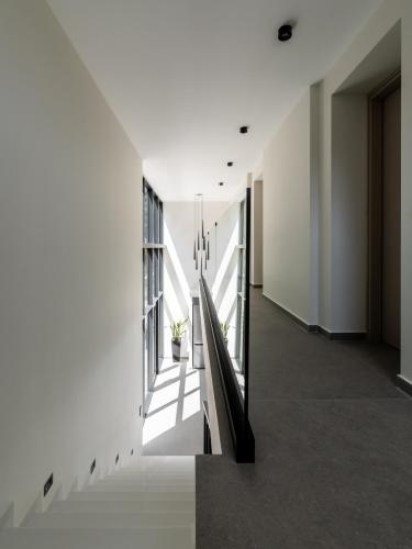 a hallway of a building with white walls and a staircase at NimVie Green Retreat in Skiathos Town