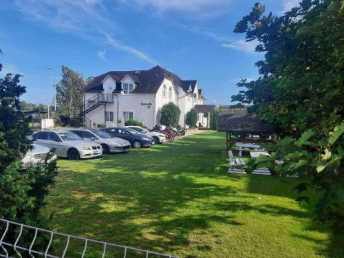 a row of cars parked in front of a house at DAGMARA in Łeba