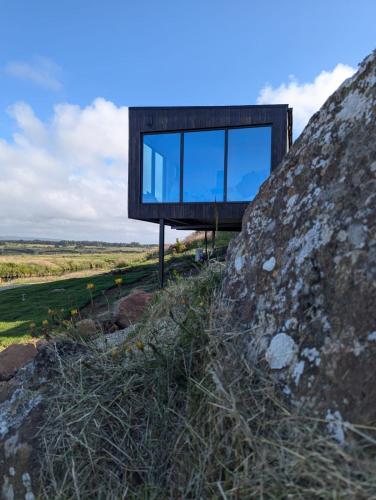 a glass house on top of a rock at Carrick-a-Rede Luxury Retreat Ballintoy Causeway Coast in Ballintoy