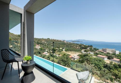 a view from the balcony of a house with a swimming pool at NimVie Green Retreat in Skiathos Town