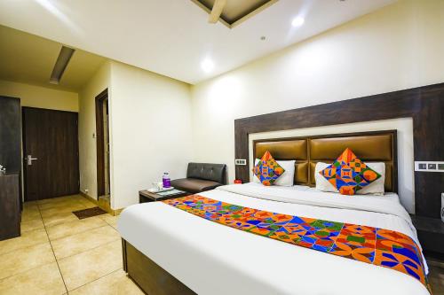 a bedroom with a large bed in a room at FabHotel Nanda Civil Lines in Ludhiana