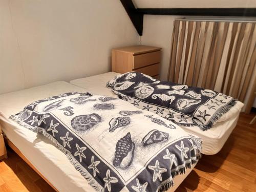 a bedroom with two beds with a blanket on them at Barkas 18 in Nieuwpoort